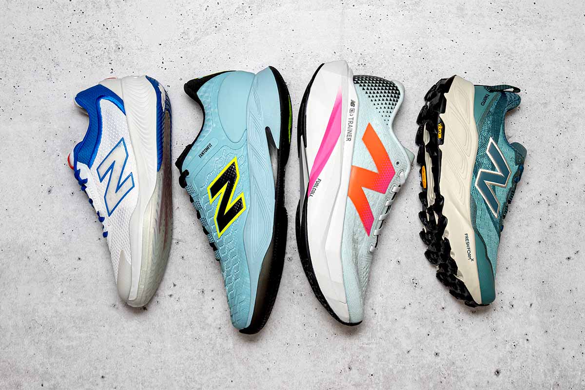 Assorted New Balance running, tennis and pickleball shoes lined up on a white concrete surface