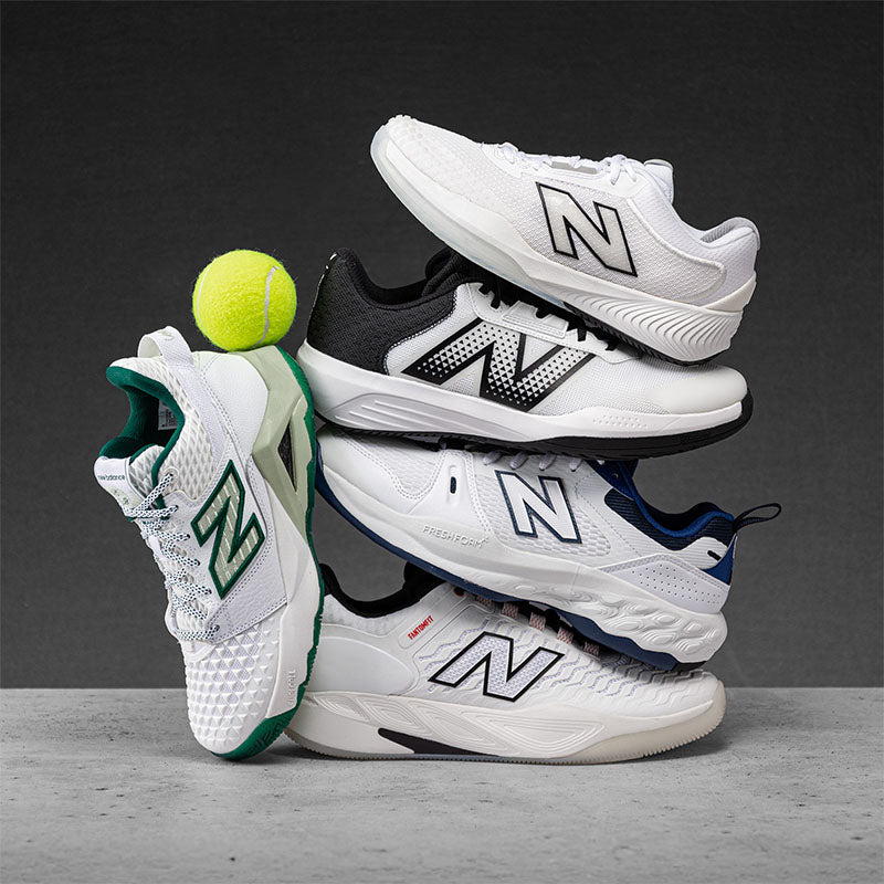 Stack of New Balance tennis shoes with a tennis ball on a gray background