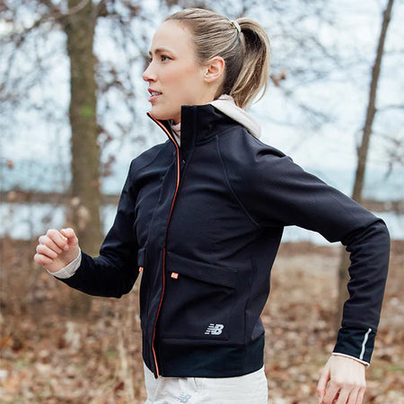 woman walking with black new-balance jacket