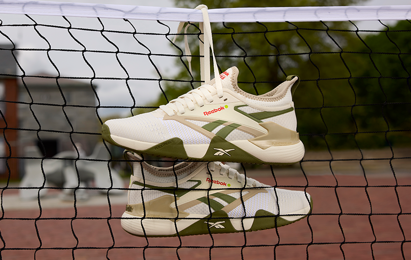 The Reebok Nano Court pickleball shoes designed in collaboration with Recess hanging over a pickleball net