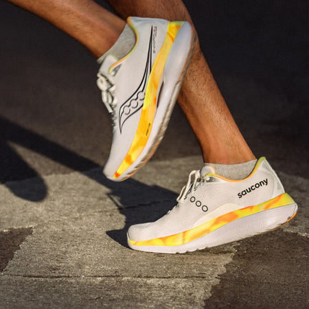Person wearing Saucony Endorphin Trainer running shoes on a pavement