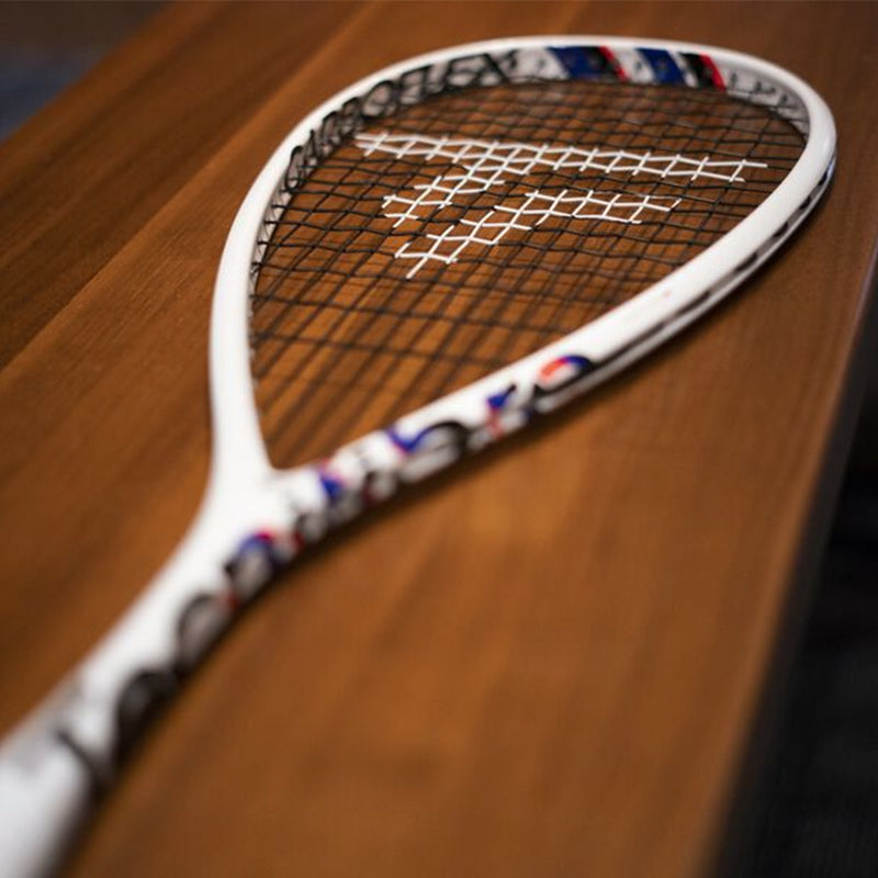 Tecnifibre Carboflex X-Top squash racquet laying on a wood surface