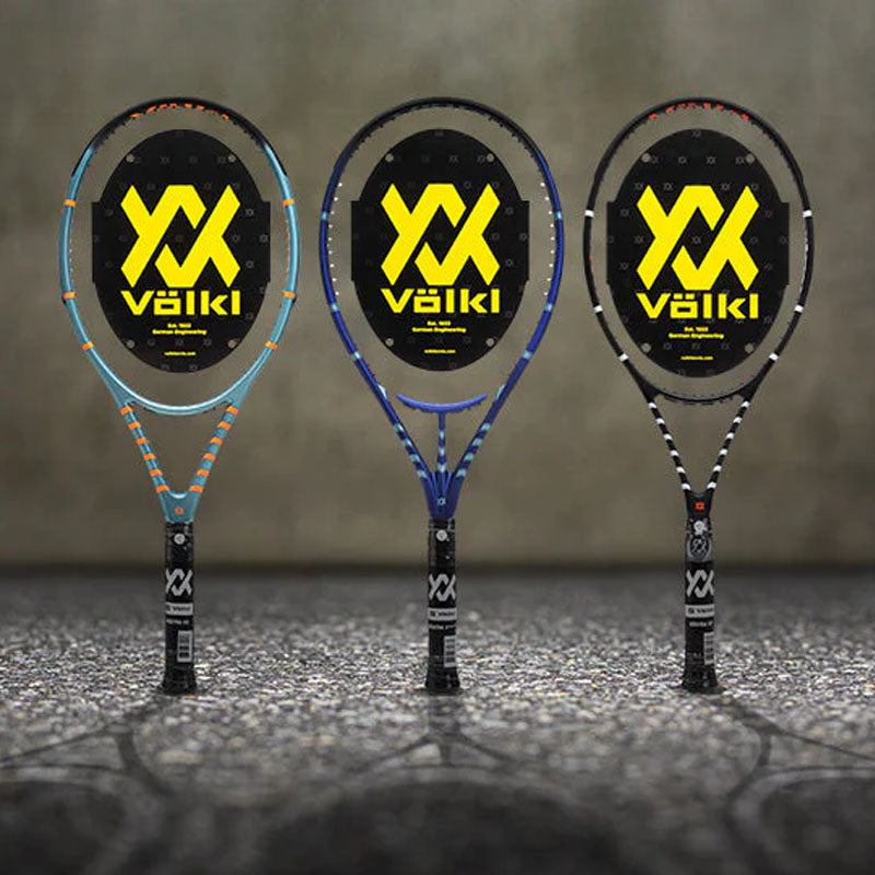 Three unstrung Volkl Vostra tennis racquets with black and yellow logo on a blurred background