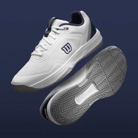 White Wilson Courtglide tennis shoes with navy accents on a dark blue background