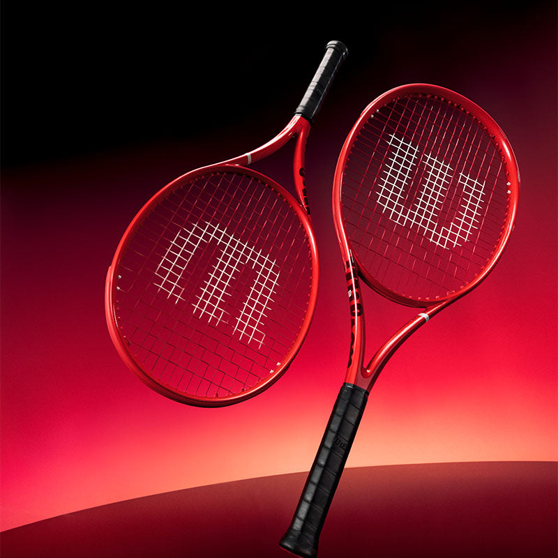 Two Wilson Defyer tennis racquets against a red gradient background